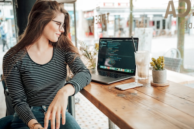 "Senior Network Engineer reviewing cloud infrastructure configurations on laptop in modern workspace