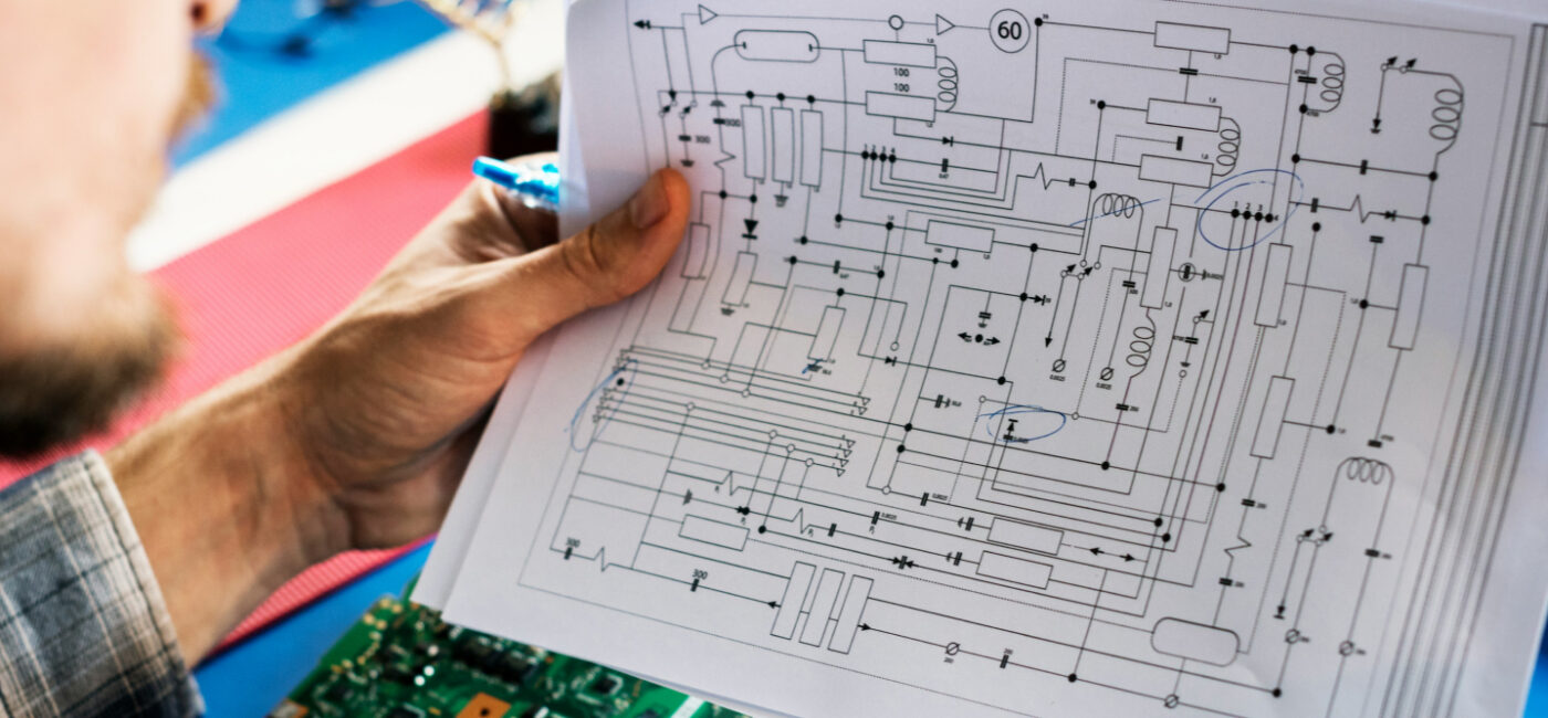 CMMC compliance engineer reviewing network architecture diagrams