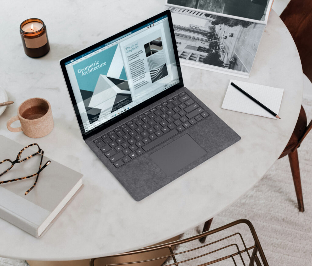 Cloud infrastructure architect reviewing technical diagrams on Microsoft Surface laptop