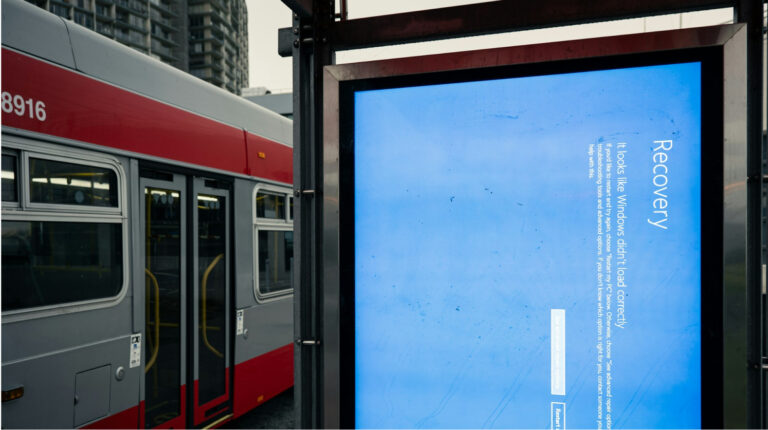 Digital display showing a Windows recovery screen at a public transit stop